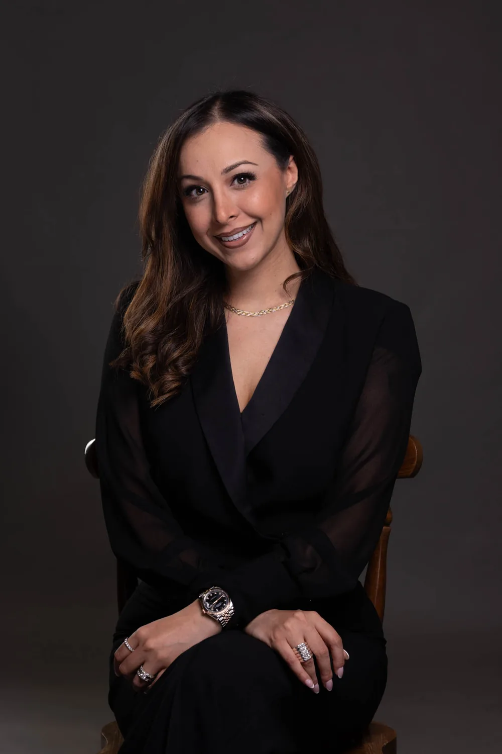 Tanya Gulati seated, wearing black